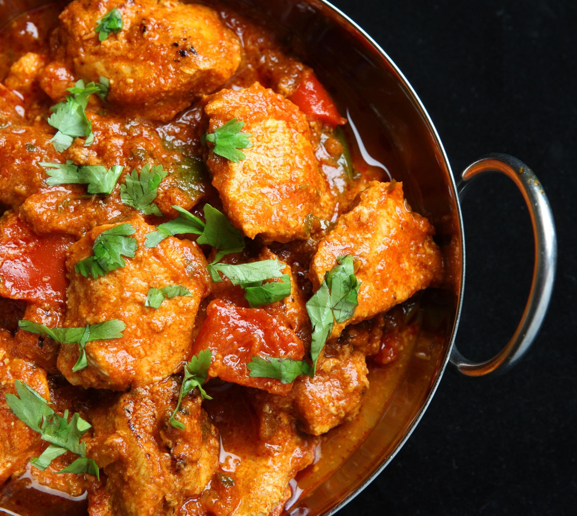 Chicken karahi simmered with tomato, ginger and chilli in a traditional copper karahi